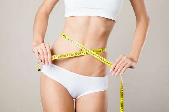 Woman measuring her waistline. Perfect Slim Body. Diet