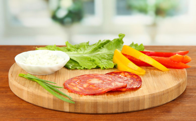 Ingredients for preparing salami rolls, on bright background