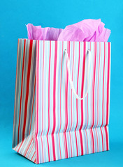 Striped shopping bag on blue background