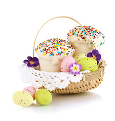 Easter cakes with eggs in wicker basket isolated on white