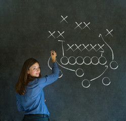 Woman with American football strategy on blackboard