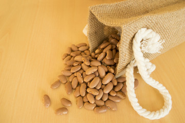 Pinto beans, Phaseolus vulgaris, on wood background