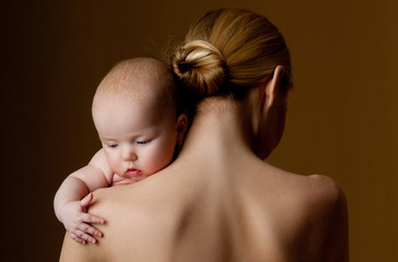 young mother holding a baby in her arms - 51503986