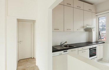 White apartment Interior, view of the kitchen