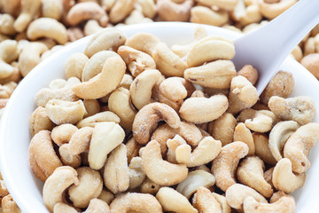 Salted Cashews in White Bowl with Spoon