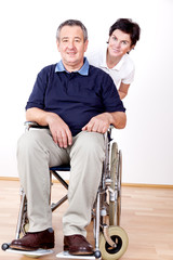 Woman is friendly and shoves man in wheelchair
