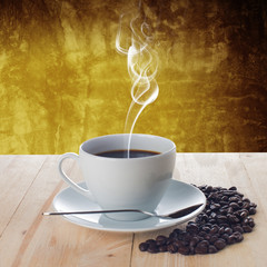 Hot cup of coffee with smoke on wood table