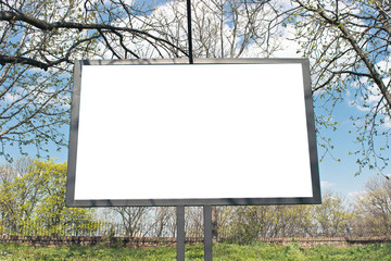 Blank billboard in a park with blue sky