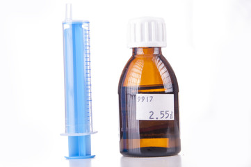 Syringe and sirup isolated on white