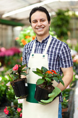 Employee in the greenhouse holding a vase