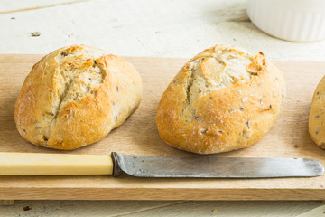 Two bread rolls on a board