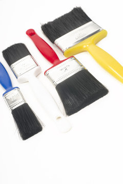 Colorful Tools for Creating Paint Brushes Lay Together on White