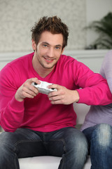 Young man with video game controllers