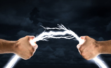 Hands bending lightning bolt