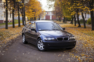 Blue colored car in autumn street