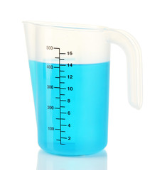 Measuring cup with blue liquid isolated on white