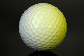 Golf ball on grey background