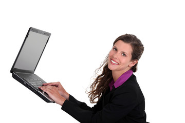 Woman typing on a laptop in mid-air