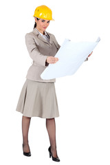 A female architect checking her plans.