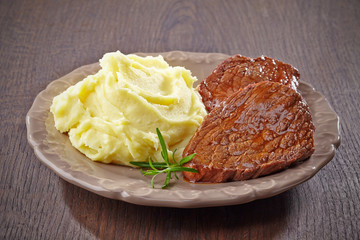 mashed potatoes and beef steak on plate