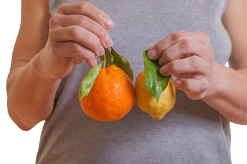 Lemon and orange in hands.