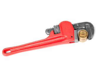 Bright red monkey wrench with a gold coins
