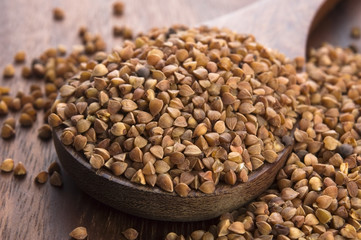 Buckwheat seeds on wooden spoon in closeup