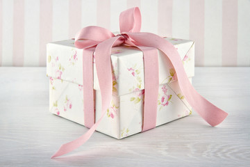 Gift box tied with pink ribbon