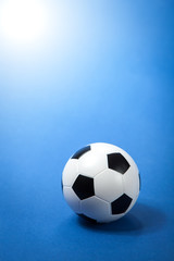 Fototapeta na wymiar Soccer ball on blue