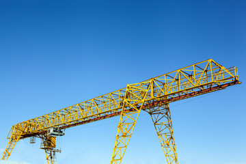 Gantry crane over blue sky