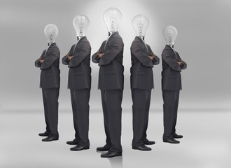 Businessman with bulb head on grey background