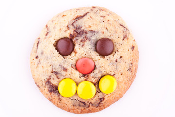 face on chocolate chip cookie
