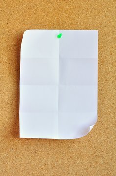 White sheet pinned on cork bulletin board