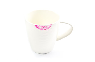 Red lipstick mark on a white tea cup isolated