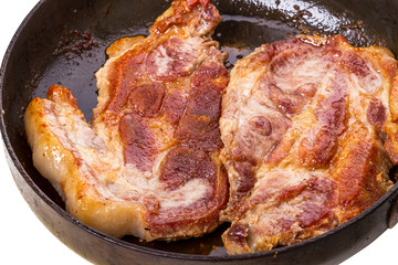 Roast pork in a frying pan closeup