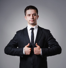 businessman holding two thumbs up