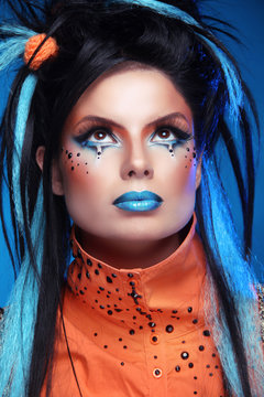 Makeup. Punk Hairstyle. Close up portrait of Rock girl with Blue