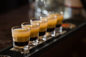 Shots with rum and liquor in cocktail club