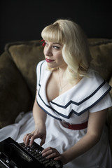 Fototapeta premium Beautiful Young Woman with Blond Hair Typing