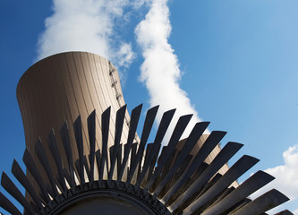 Steam turbine against nuclear power plant and sky