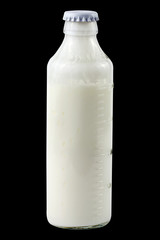 Glass bottle of kefir with scale isolated on black background