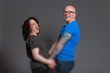 Happy young couple in love together. Studio shot.