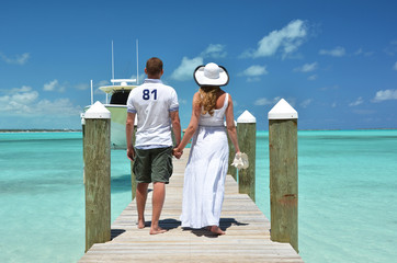 Couple on a wooden jetty. Exuma, Bahamas