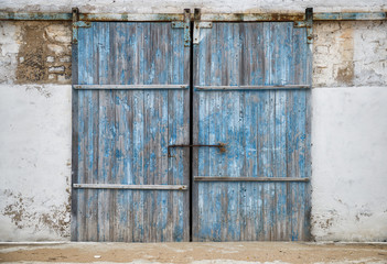 wall of ancient wooden barn with door