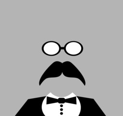 man wearing tuxedo and reading glasses