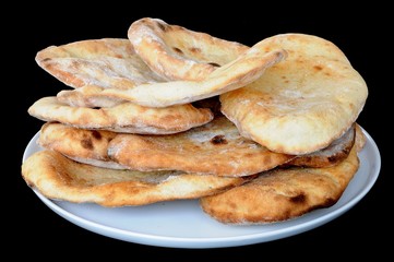 Naan breads stacked on a plate © Arena Photo UK