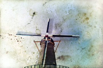 Vintage photo of dutch windmill over blue sky