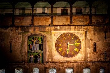 Old clock in Sighisoara medieval city, photo taken night time