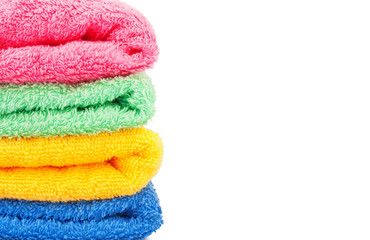 Colored bath towels, soft terry on white background