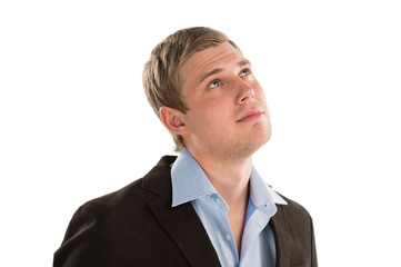 Successful young businessman looking away against white backgrou